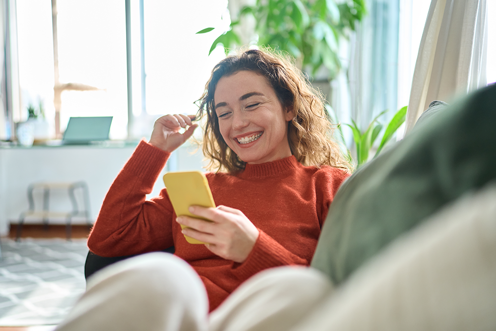 woman-laughing-at-her-phone